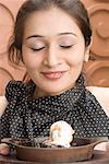 Close-up of a young woman with an ice cream in front of her