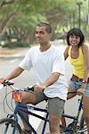 Couple sitting on a tandem bicycle