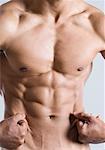 Mid section view of a young man showing his abdominal muscles