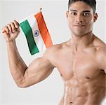 Portrait of a young man holding the Indian flag