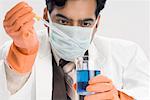 Close-up of a male scientist performing an experiment in a laboratory