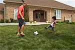 Father and Son Playing Soccer