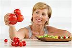 Senior woman holding tomatoes