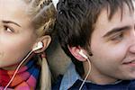 Young couple listening to music about earphones