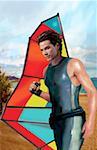 Jeune homme posant sur la plage avec sa voile windsurf