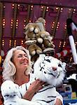 Woman at Amusement Park, Holding Stuffed Animal