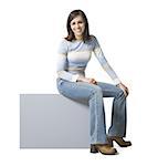 Woman sitting on blank sign