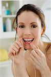 Woman Flossing Teeth