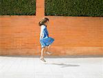 Little girl  (5-7) skipping down pavement, Alicante, Spain,