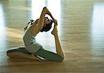 Woman doing one-legged king pigeon pose