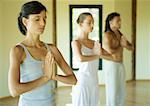 Yoga class standing in prayer position