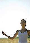 Woman doing yoga pose in field