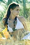 Young woman lounging in field