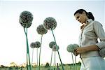 Woman standing with allium flowers