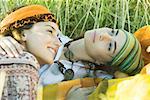 Femme jeune hippie, couché dans l'herbe, embrassant