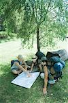 Three hikers studying map