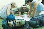 Three hikers studying map