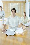 Group meditation, adults sitting in different positions