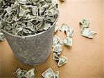 Waste paper basket with crumpled money