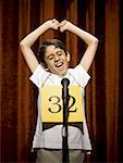 Boy contestant standing at microphone cheering