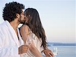 Couple kissing outdoors with champagne flutes