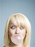 Woman blowing bubbles with chewing gum