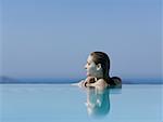 Woman in infinity pool reflection