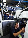 Man Working on Car in Factory