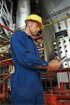 Worker at Water Treatment Plant with Electronic Organizer