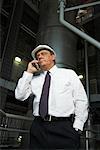 Businessman with Cellular Phone in Water Treatment Plant