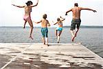 Family Jumping from Dock