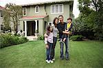 Portrait of Family in Front of House