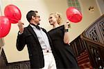 Couple with balloons on a staircase