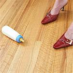 Woman's Feet Next to Baby Bottle on Floor