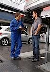 Mechanic and Man in Garage