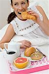 Woman Eating Breakfast in Bed