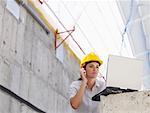 Engineer Talking on Cell Phone, Using Laptop Computer