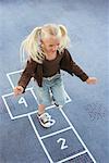 Child Playing Hopscotch