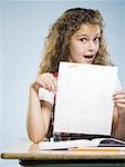 Schoolgirl holding A plus paper