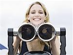 Woman with coin operated binoculars smiling