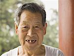 Portrait of a toothless man outdoors smiling