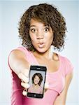 Girl with braces holding cell phone