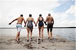 Couples Jumping off Dock