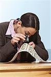 Businesswoman Inspecting Money