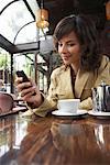 Woman Using Cellphone at Cafe