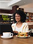 Woman Using Laptop in Cafe