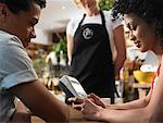 Couple and Waitress in Cafe