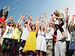 Crowd of young people cheering and waving