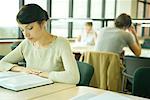 Young woman studying in university library