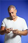 Man Looking at Pill Container